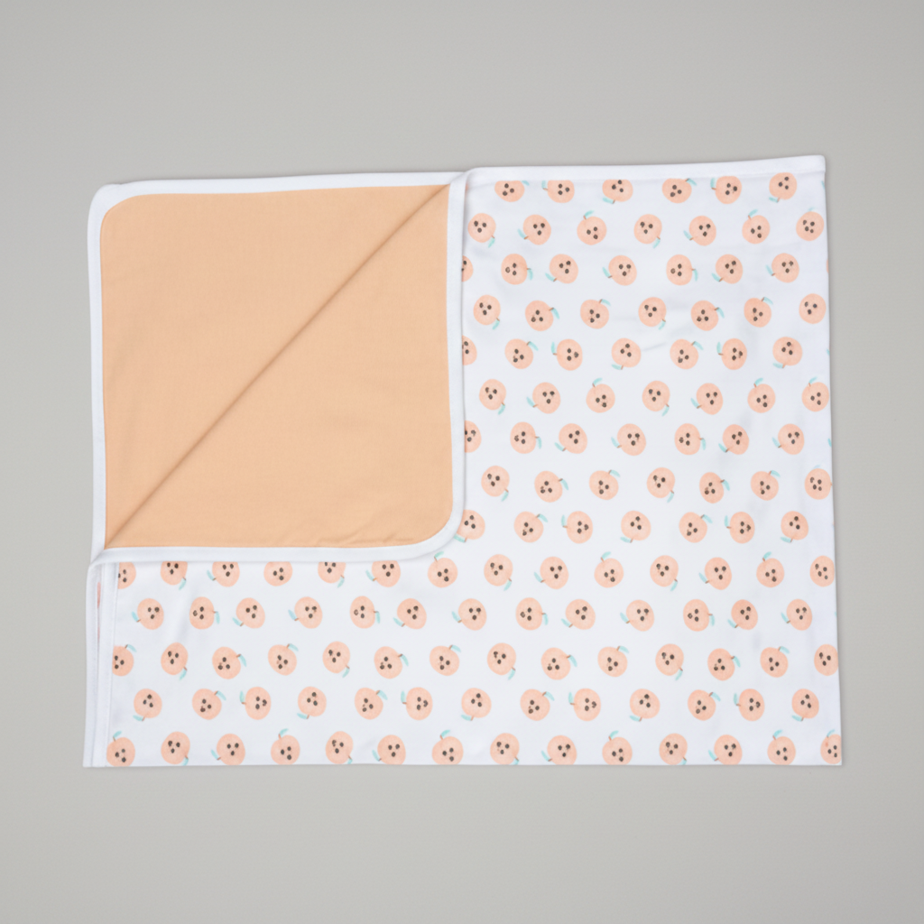 Baby blanket with floral pattern on one side and solid color on the other, on a white background